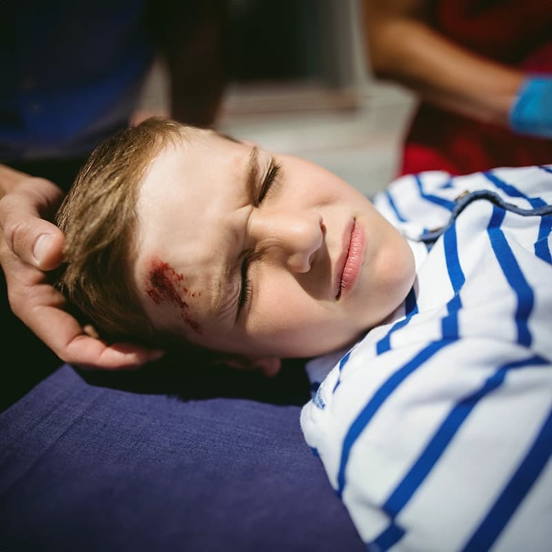A child collides with a rigid metal bollard.