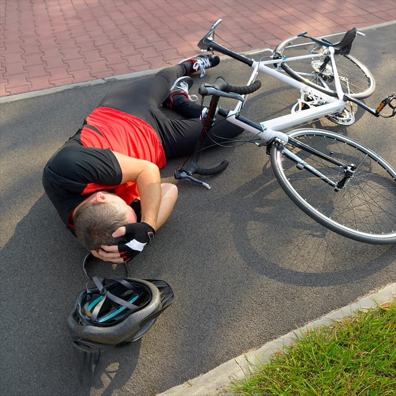 A cyclist or pedestrian strikes a rigid obstacle in poor visibility.